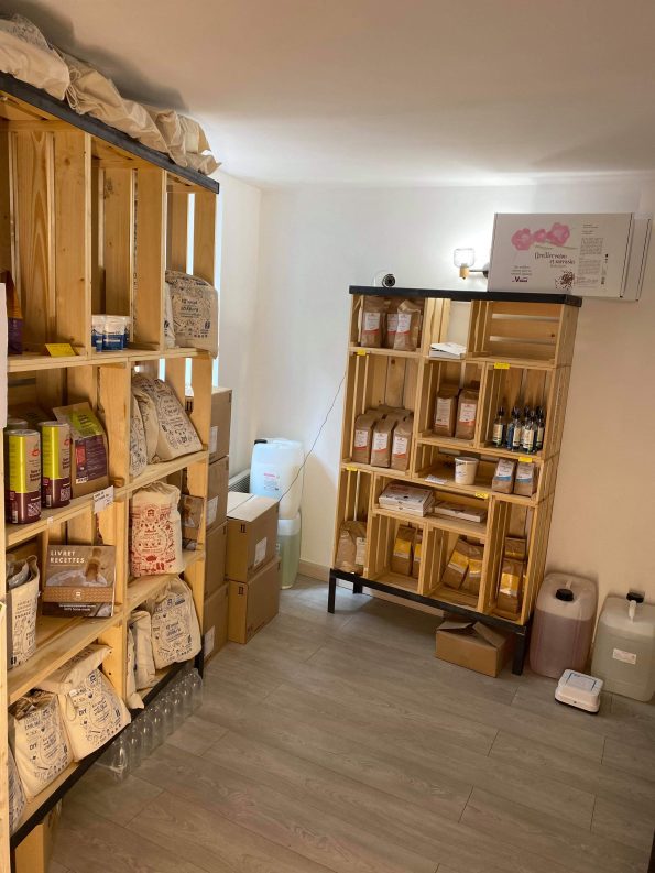 Une allée du magasin et ses étagères en bois clair